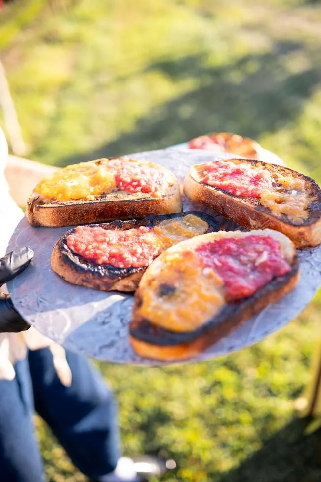 Charred bread plated with fresh toppings
